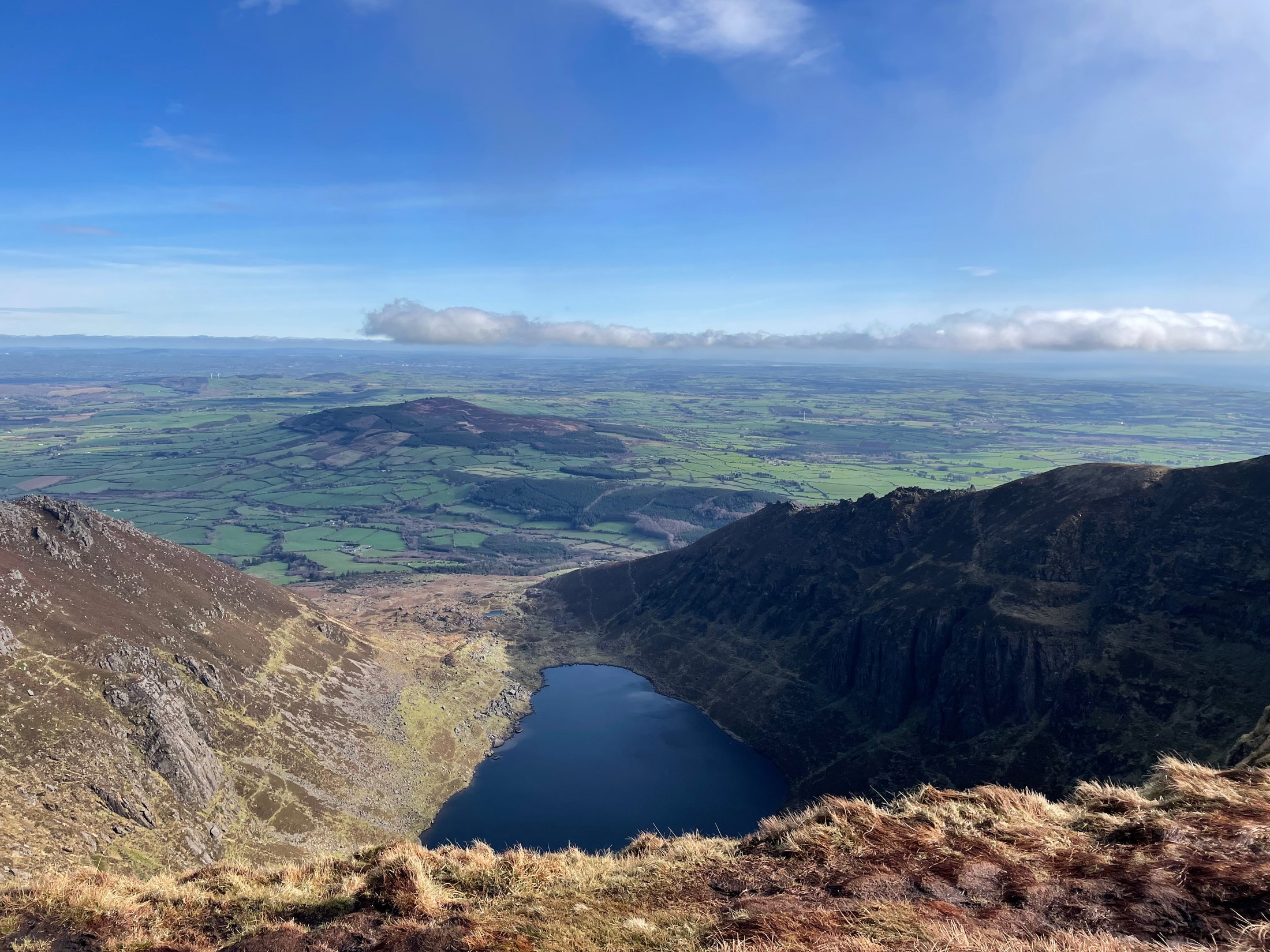 Mountain landscape overlooking a lake and green countryside in Ireland